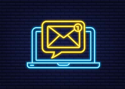 Neon blue outline of computer with yellow neon chat bubble with envelop on black background