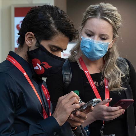 Two people compare schedules during the International Stroke Conference.