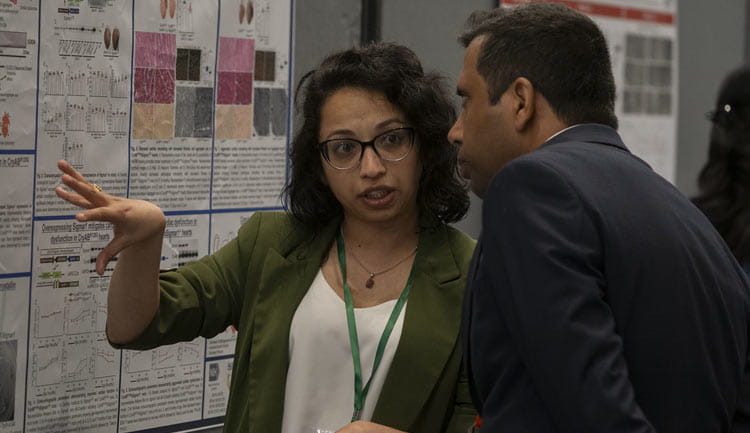 A poster presenter explains her science to a visitor during the Asian Cardiovascular Society meeting, held Tuesday, July 22, 2025, just before #BCVS25 began.