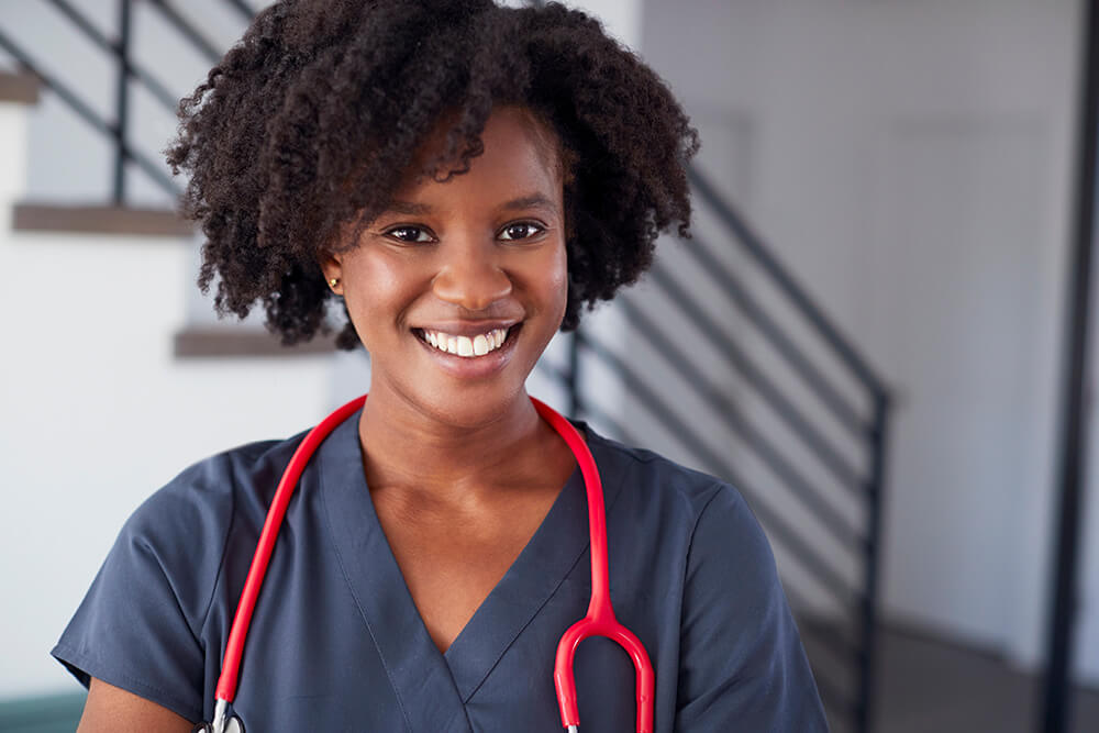 smiling female nurse wearing scrubs head shot of male african american doctor