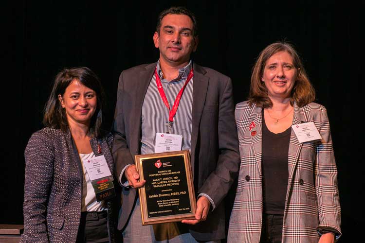 Winner Ashish K. Sharma is flanked by Aruna Pradhan and Naomi Hamburg.