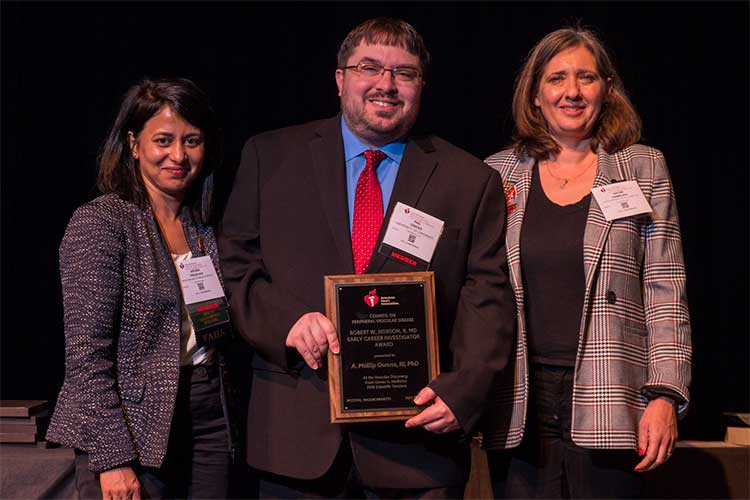 Winner A. Phillip Owens III is flanked by Aruna Pradhan and Naomi Hamburg.