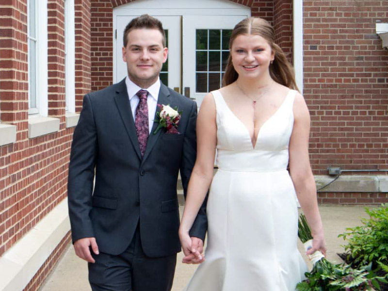 Heart transplant recipient Katherine Herrmann (right) with her husband, Ian, on their wedding day in 2023. (Photo courtesy of Devin Hill)