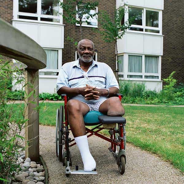 man in wheel chair in a garden