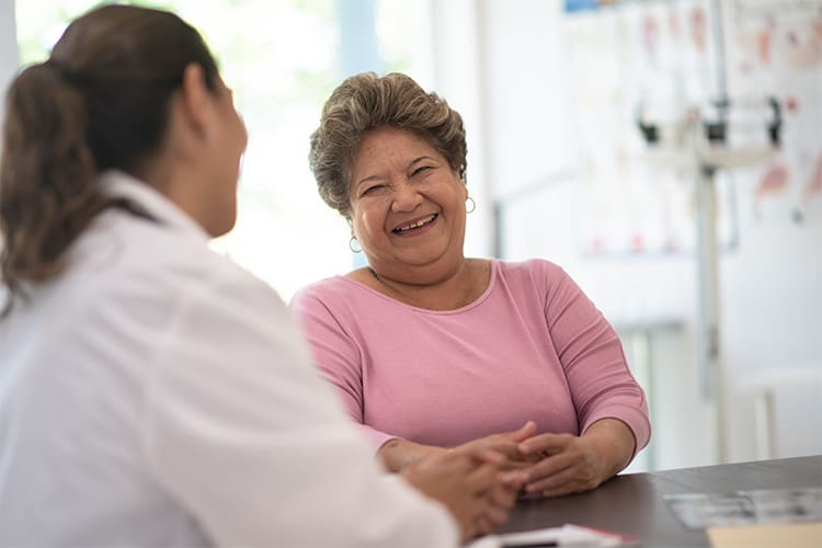 Older lady talking with her doctor.