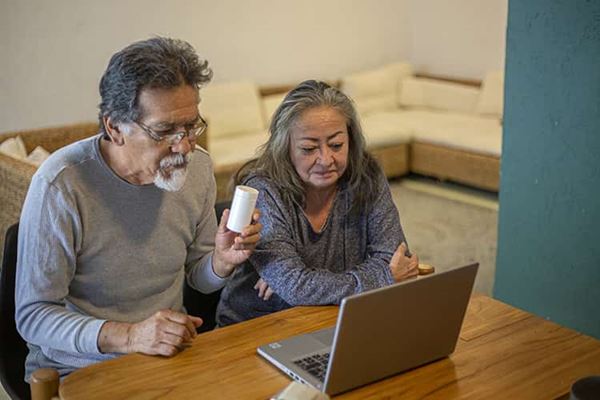 Couple sitting in front of a computer doing a search