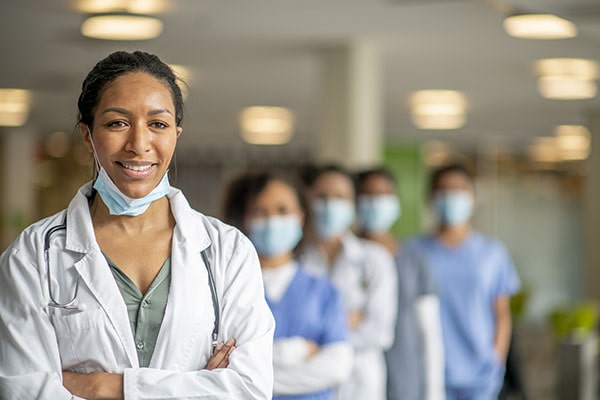 An image of healthcare workers with masks standing behind each other.
