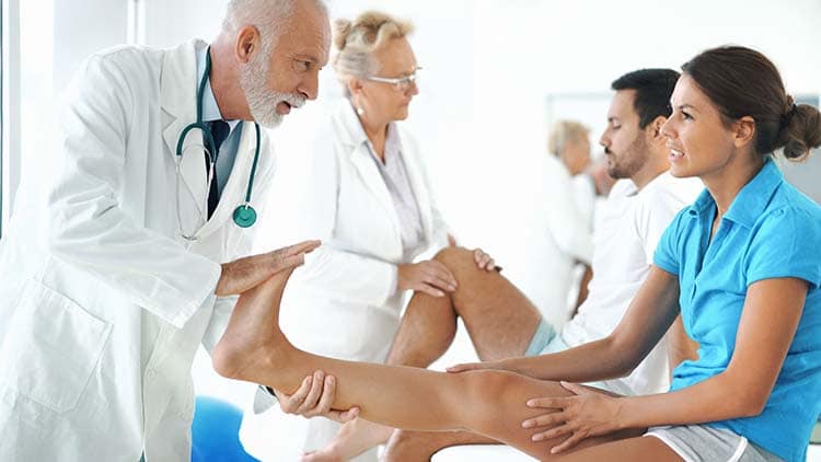 Doctors examining ankles and knees of patients