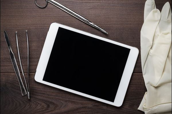 A table with tablet computer tools and gloves