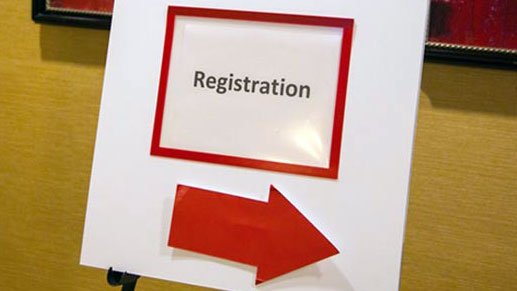 A sign on an easel points American Heart Association meeting attendees to the registration desk.