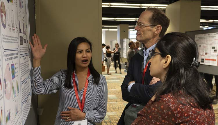 A scientists presents her study during a poster session at #BCVS23 in Boston, Massachusetts.