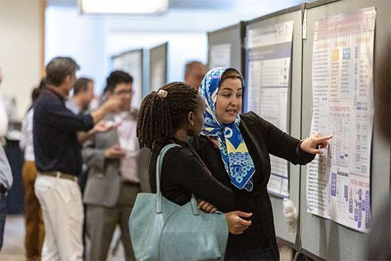 Attendees discuss brain health science presented in a poster at the international Stroke Conference