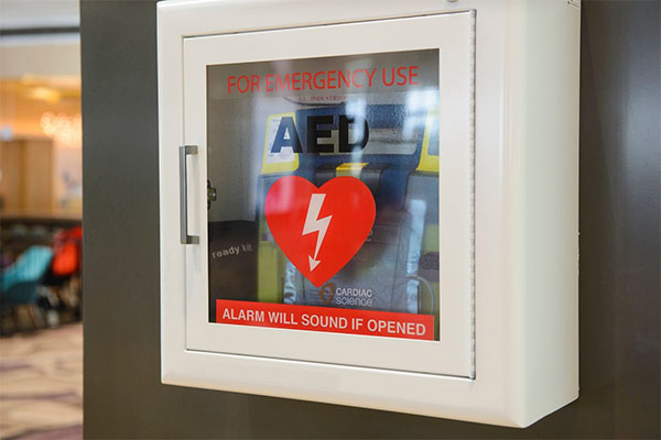 Photo of automatic external defibrillator device on wall of office