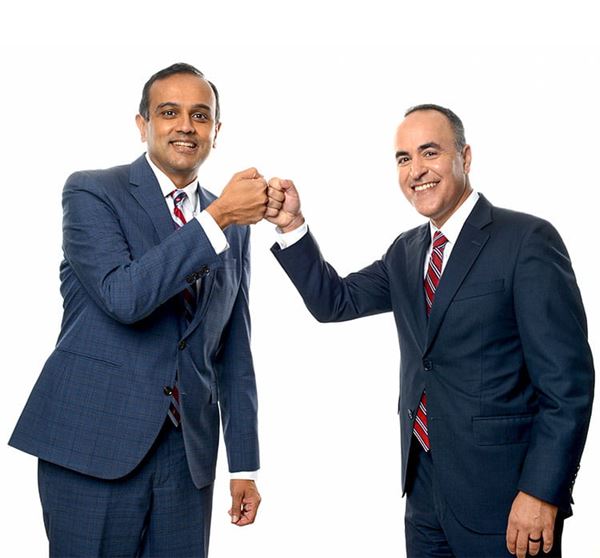 Manesh R. Patel, MD and Amit Khera, MD are photographed bumping fists.