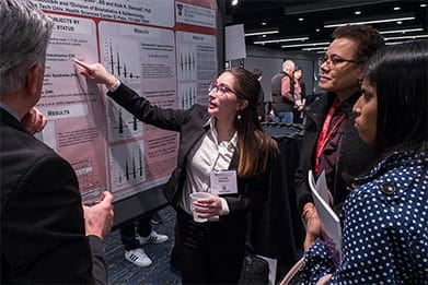 Cardiovascular and stroke professionals viewing a poster during an American Heart Association scientific meetings