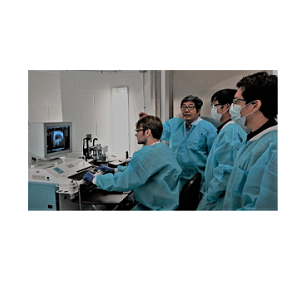 Image of Xupei Huang, MD, PhD, instructing graduate students in front of a computer screen.