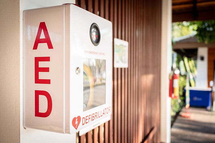 An Automated External Defibrillator, (AED) placed on the wall in a public location.