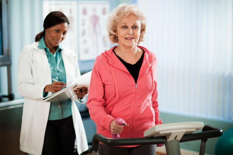 active senior woman exercising on treadmill