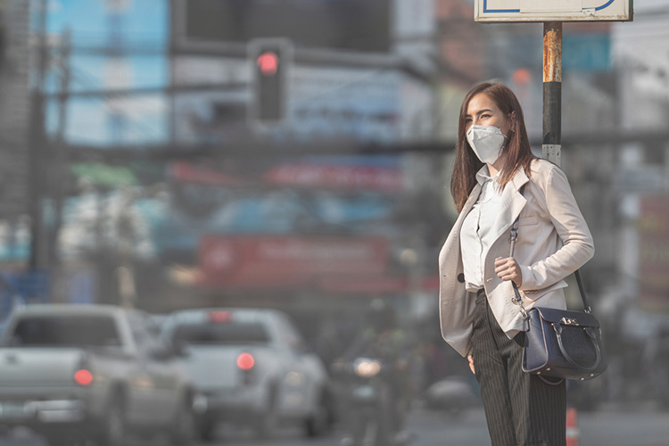 Asian woman going to work, she wears N95 mask to prevent PM2.5 dust