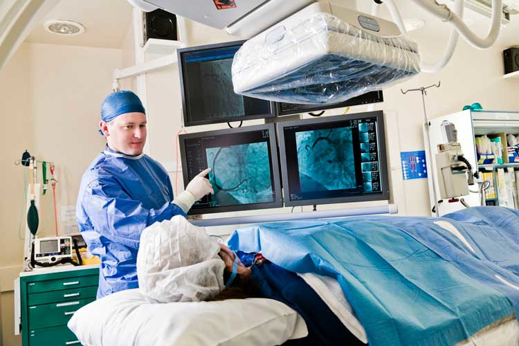 Cathlab in modern hospital with doctor and patient