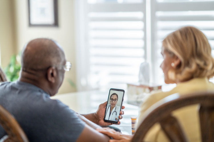 couple speaking with doctor via video call