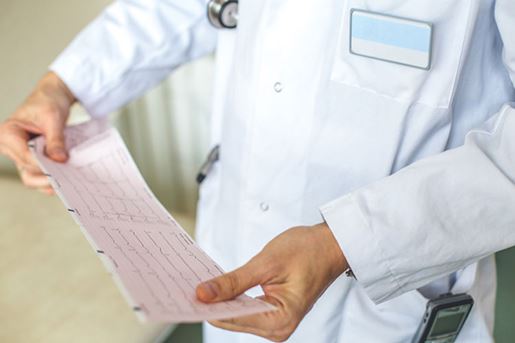 doctor holding electrocardiogram results