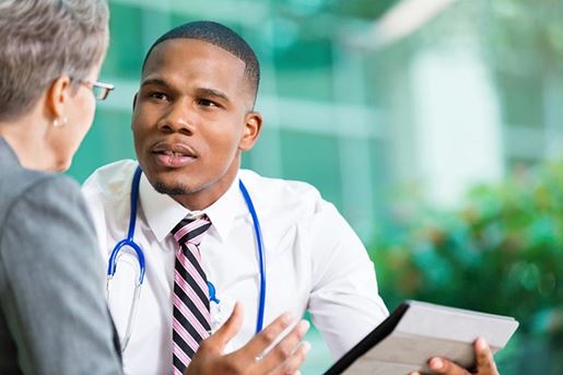 doctor meeting with senior patient using digital tablet