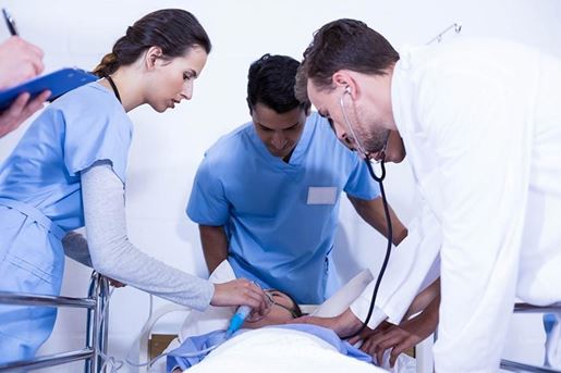 doctors examining a patient on bed