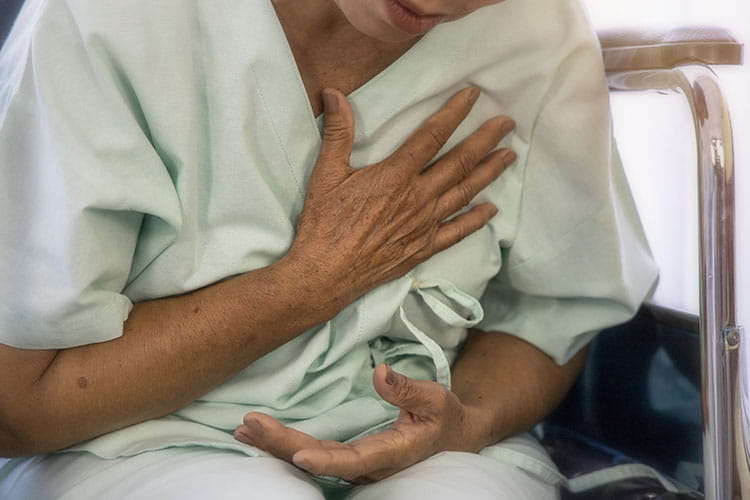 elder female suffering from chest pain