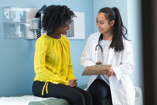 Ethnic woman in medical consultation with female doctor
