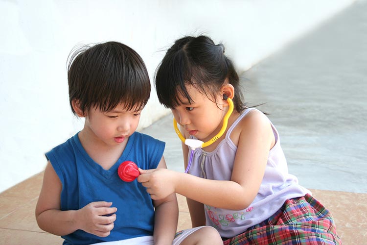 girl and boy playing with stethoscope