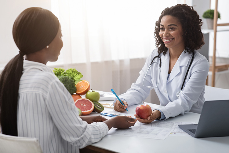female nutritionist consulting a female patient about healthy eating