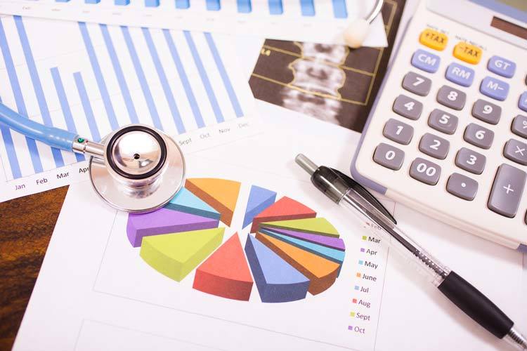 healthcare statistics, stethoscope, and financial charts