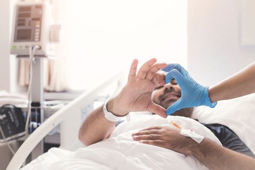 Male patient making a heart shape with doctor