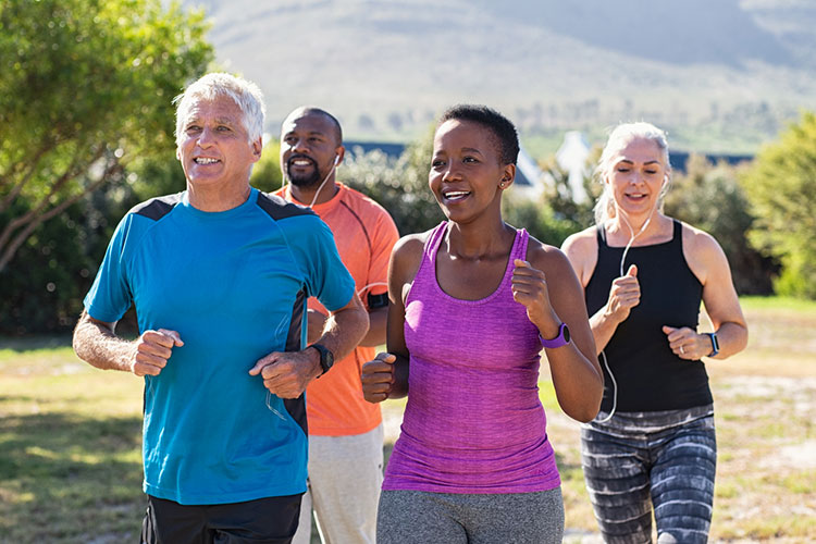 Multiethnic middle-aged friends exercising together outdoor.