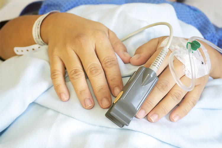 patients hands with an IV drip