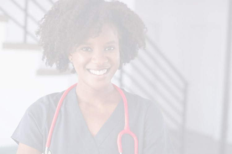 Portrait of a young, black female nurse wearing dark blue scrubs In the hospital