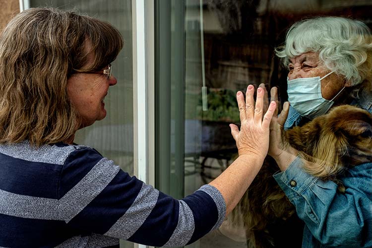 Quarantined senior sees daughter through window