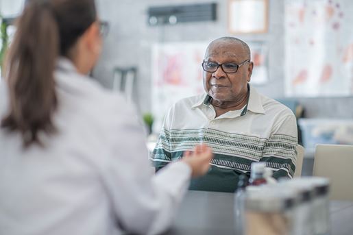 Senior African American man listening to his female doctor during a medical appointment