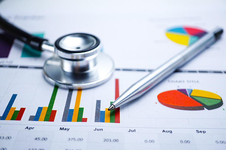Stethoscope and pen on chart or graph paper, Financial, account, statistics and business data concept.