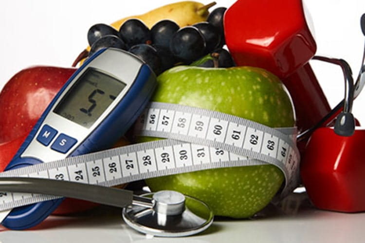 Stethoscope with blood sugar control glucometer glucose meter, fruits and dumbbells