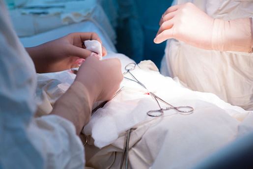 surgeon and assistant working in sterile room