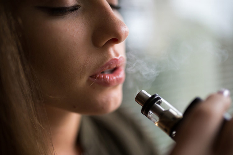 woman smoking an e-cigarette