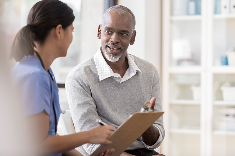 man talking to woman medical professional man talking to woman medical professional