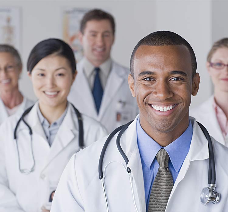 A photo of several doctors of different backgrounds smiling into the camera.