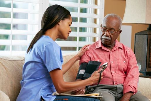 nurse visiting senior male patient at home