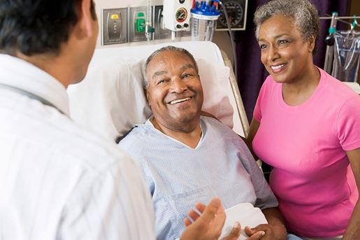 senior couple talking with doctor