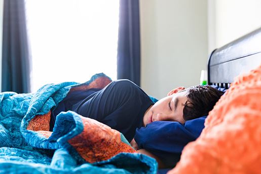 The sick teenage boy sleeps comfortably throughout the morning.