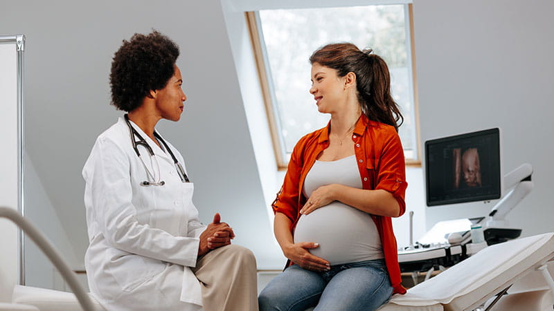 Pregnant woman consulting with her doctor during a checkup
