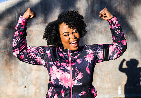 happy young woman pumping fists in success happy young woman pumping fists in success